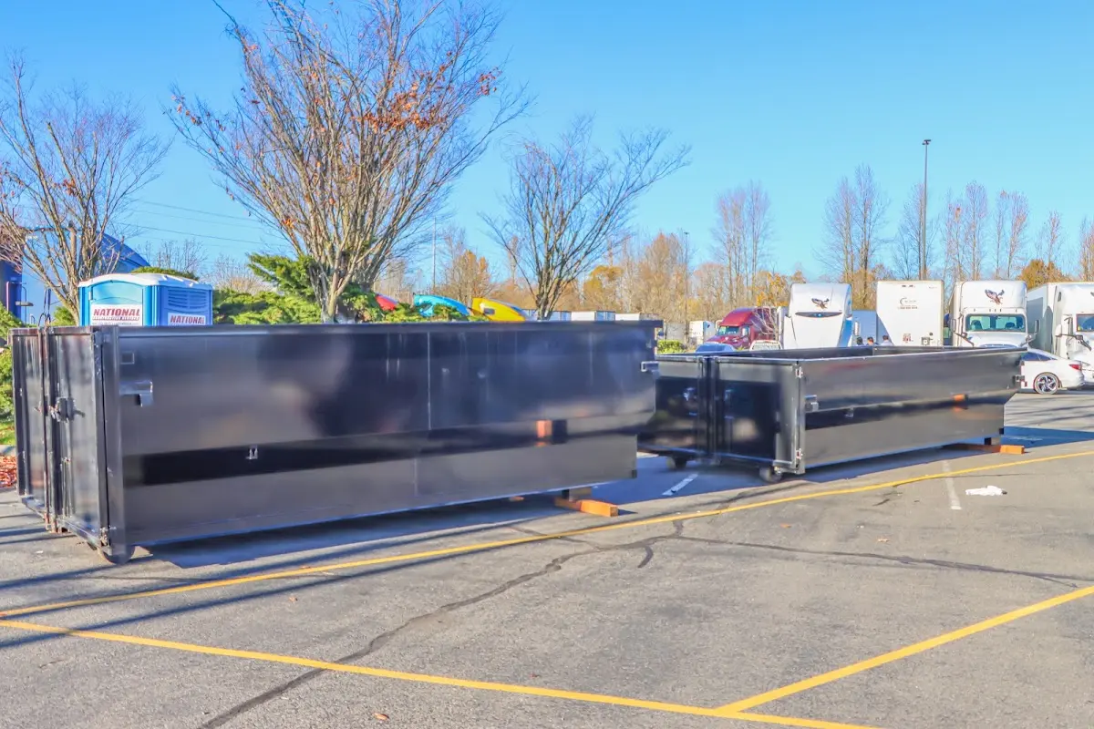 Professional dumpster rental service with roll-off container on residential driveway in Upper Darby